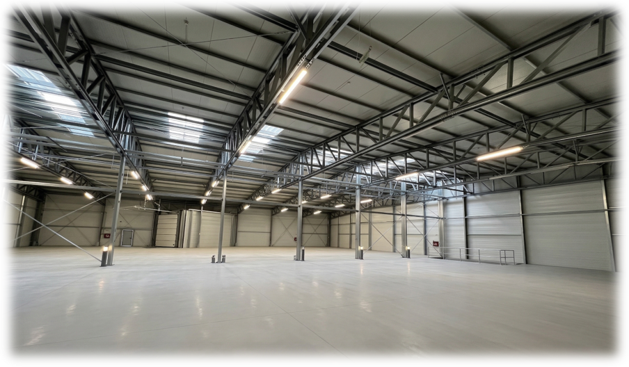 Spacious empty warehouse with steel roof structure